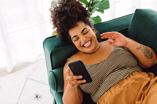 Healthy woman using smart phone on sofa