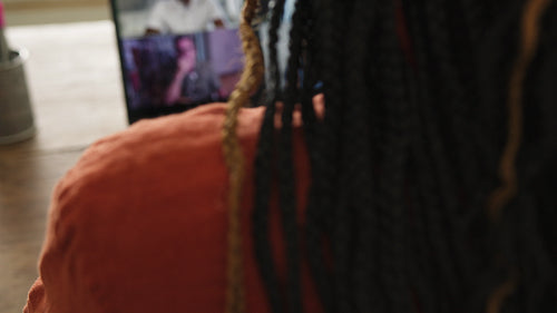 Freelance graphic designer attending an online meeting in her office