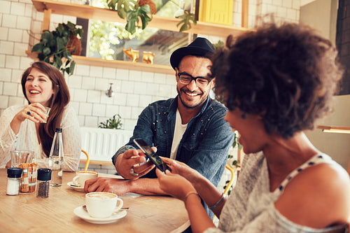 Happy young people having a great time at restaurant