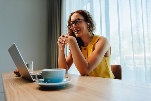 Woman smiles during video call for remote work at office