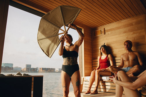 Nordic sauna ritual led by female sauna master in waterfront spa