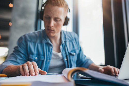 Student studying in library finding information