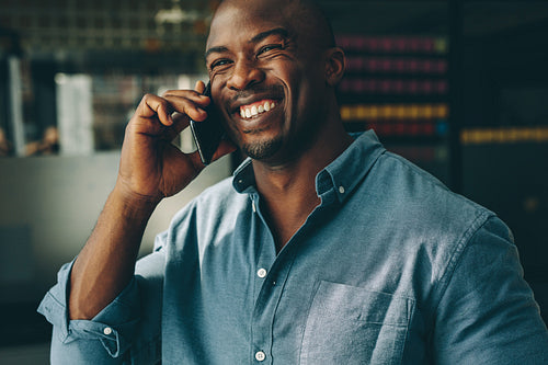 Businessman talking over mobile phone in office