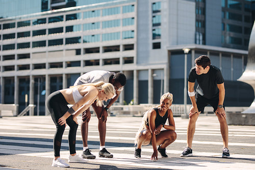 Fitness group resting after running exercise in the city