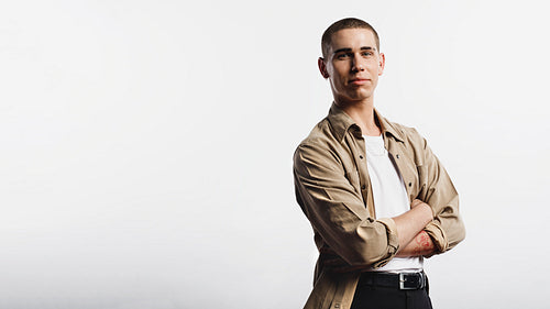 Caucasian man standing with arms crossed