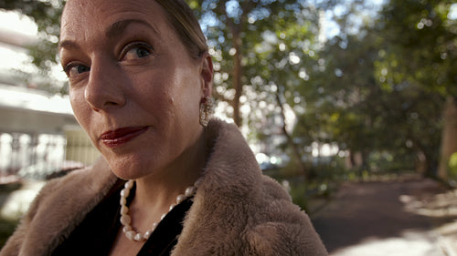 Rich female standing in the park