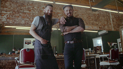 Barber with satisfied client at salon
