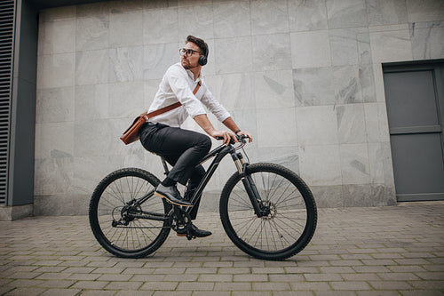 Man riding to office on a bike listening to music