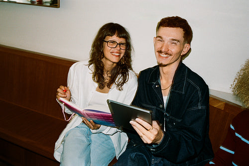 Young business people collaborating with tablet and notebook