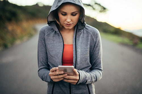 Portrait of a female athlete walking on street