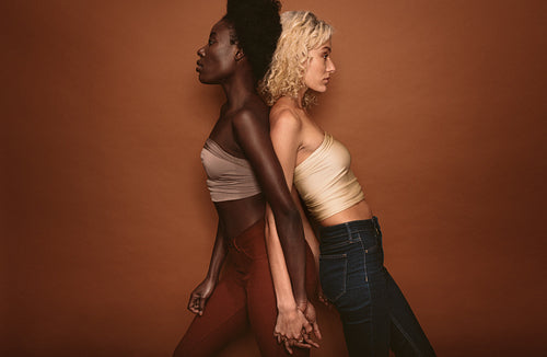 Diverse females standing on brown background