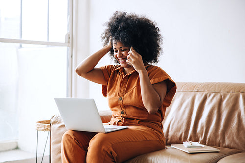 Happy female entrepreneur speaking on the phone in an office