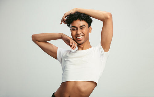 Man in crop top winking at camera