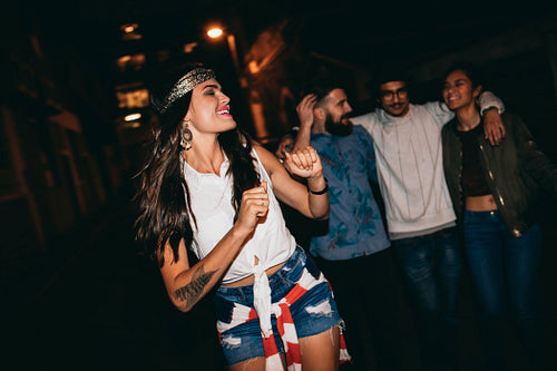 Young woman enjoying in a party with friends