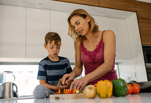 Mother and son cooking together in kitchen
