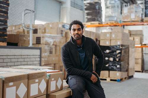 Warehouse employee looking at the camera in a logistics centre