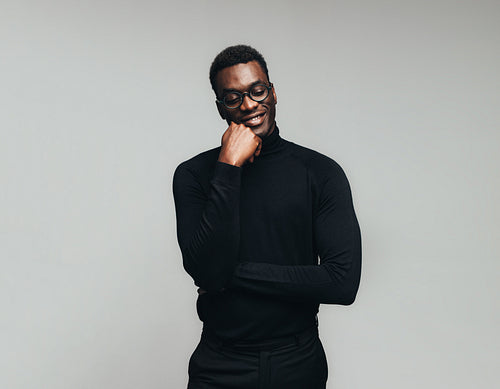 Smiling african man lost in thoughts