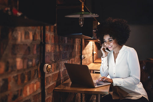 Happy businesswoman working late in office