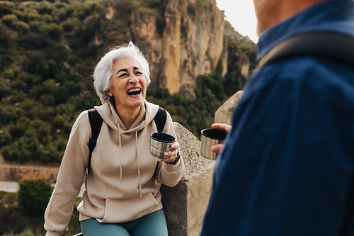 Joyful senior couple taking a coffee break outdoors