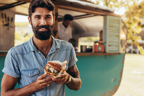 Man having food truck burger