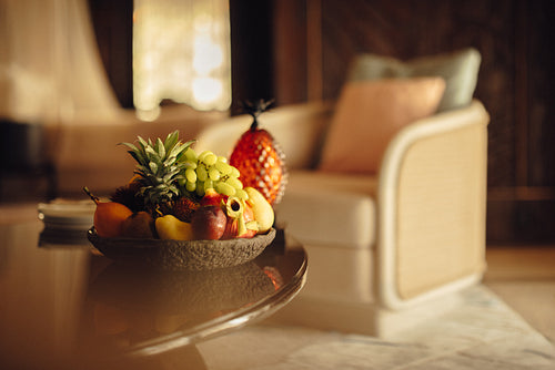 Luxurious hotel room with a vibrant fruit arrangement on the table
