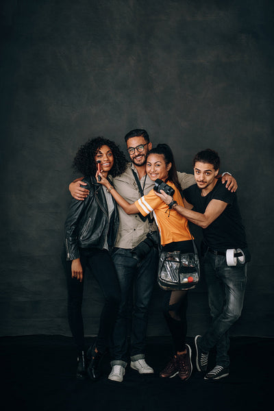 Photographer standing in a studio with his team
