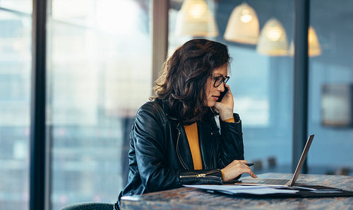 Asian woman busy working at her desk