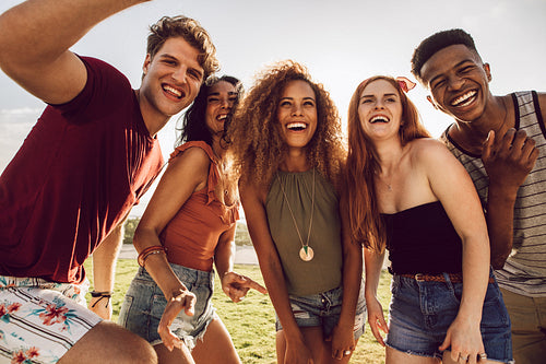 Happy young people dancing outdoors