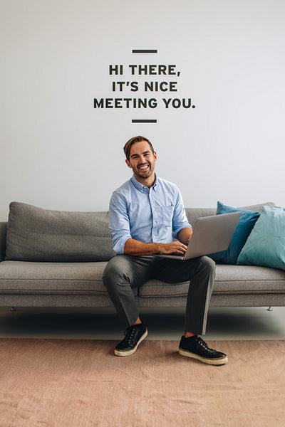 Confident executive sitting on sofa and using laptop