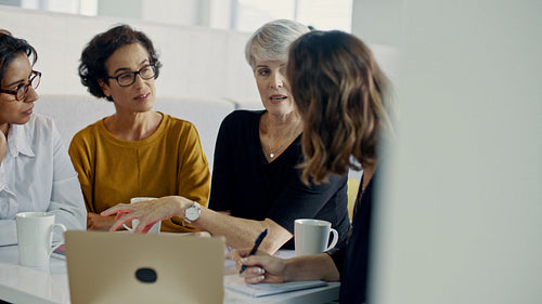 Senior manager discussing work with her team