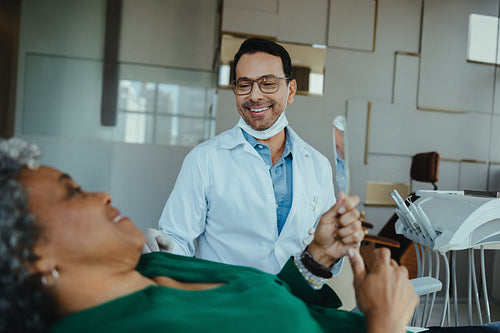 Friendly dentist engaging with senior patient during dental consultation