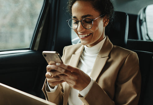 Smiling woman traveling by a car