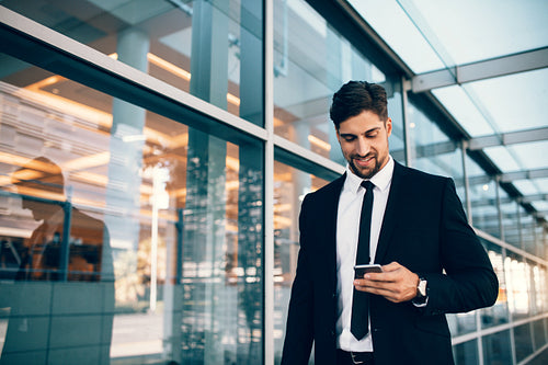 Business executive with mobile phone at airport