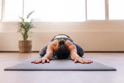 Fitness woman working out on yoga mat