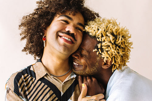 Smiling gay couple in a studio
