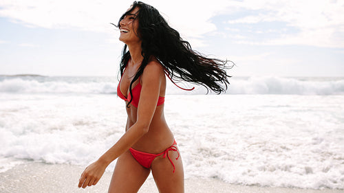 Laughing woman coming out of the sea