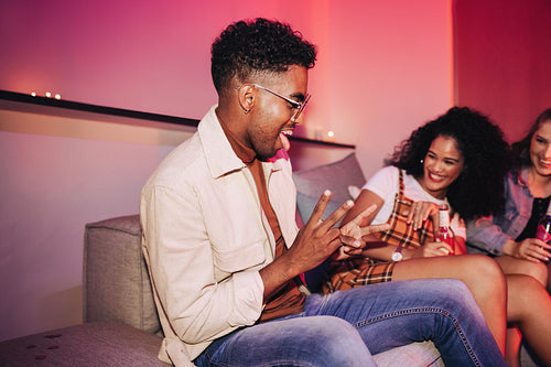 Young man showing off his dance moves at a house party