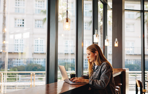 Woman doing her work sitting at a coffee shop