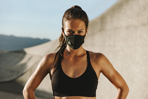 Fitness woman in sportswear and face mask