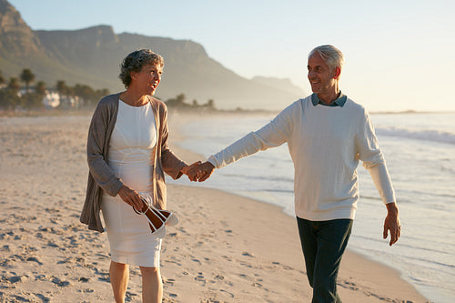 Loving mature couple strolling on the beach.