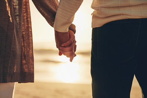 Senior couple holding hands