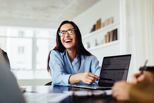 Business woman discussing a project with her colleagues in an office