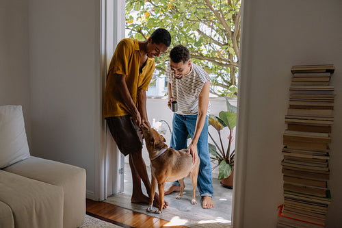 Young couple spending quality time with their dog at a cozy doorway