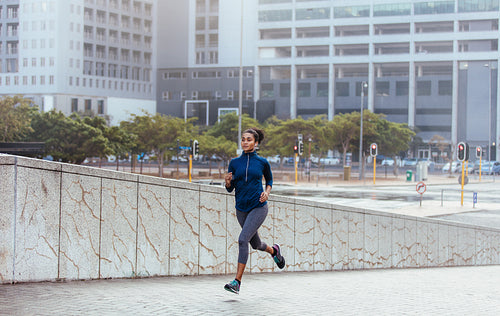 Woman running on street in the morning