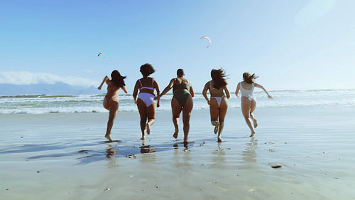 Women in swimwear enjoying themselves on beach