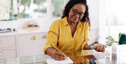 Chronic disease management: Senior woman monitoring her blood pressure at home