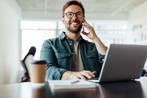 Entrepreneur making a phone call while working in an office