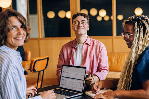Group of young professionals having a discussion around a work table