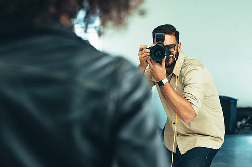 Photographer doing a photo shoot in a studio
