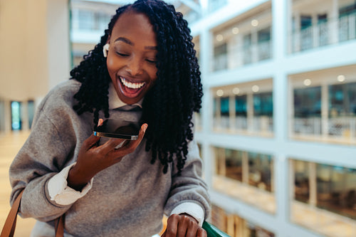 Businesswoman laughing at a voice note